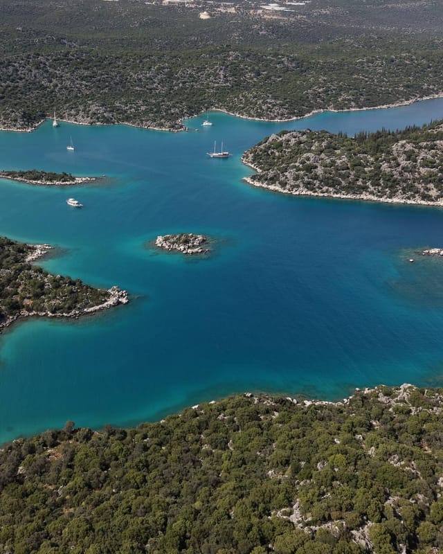 Gökkaya Bay from the air: a wide bay broken up by islets, gulets at anchor